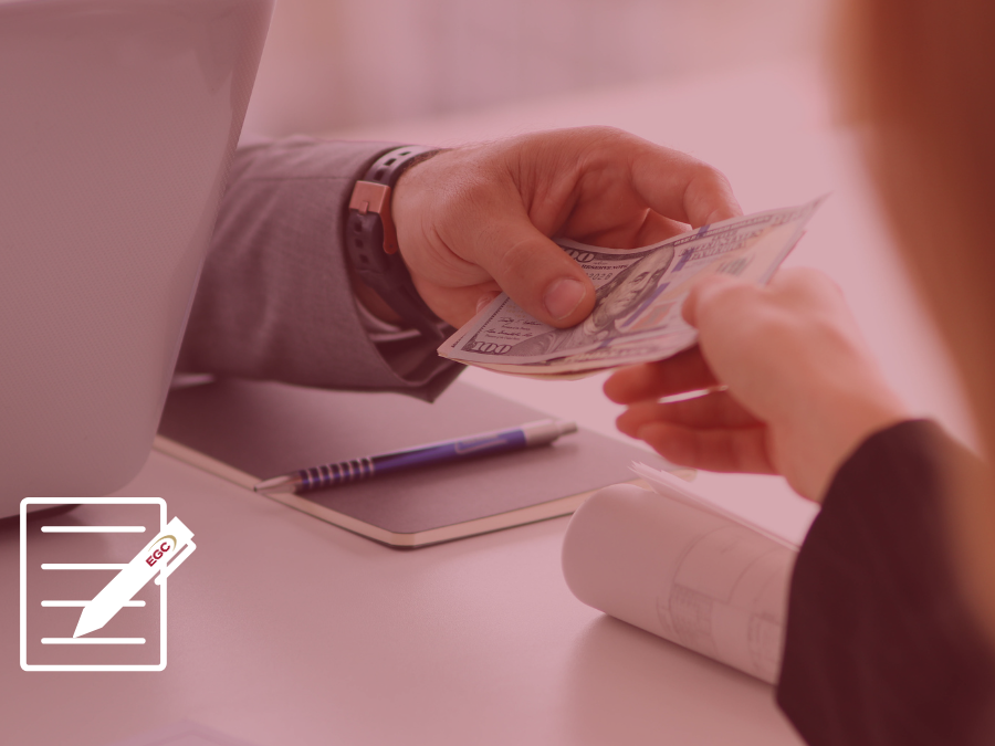 A hand transferring cash to another.